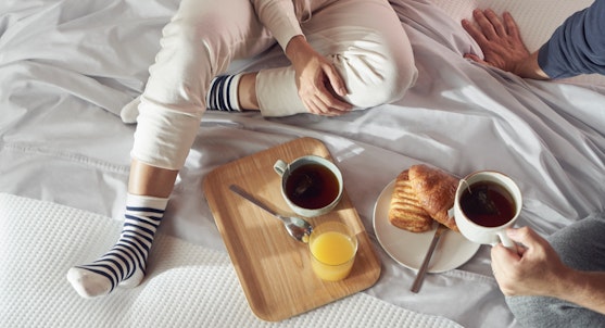 Couple eating breakfast in bed
